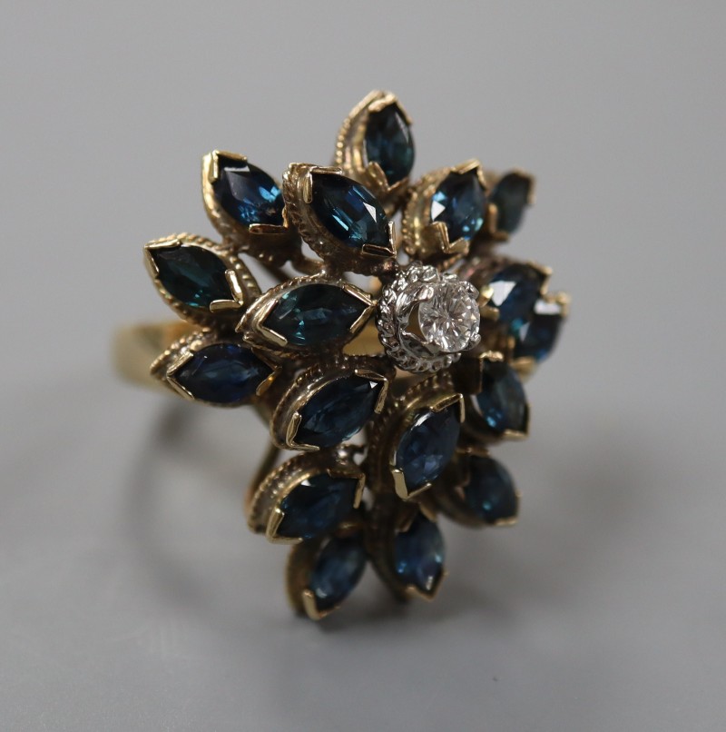 A 14k yellow metal, sapphire and diamond set raised cluster dress ring, of flowerhead design, size M, gross weight 9.2 grams.